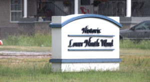 a white neighborhood sign with text that reads: Historic Lower Ninth Ward