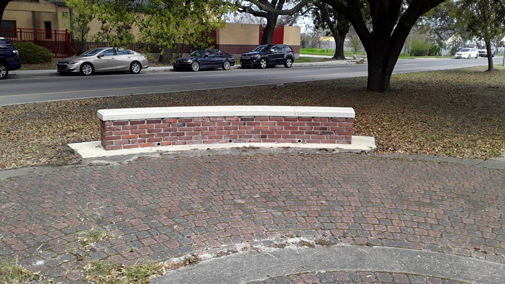 a brick bench in a public park