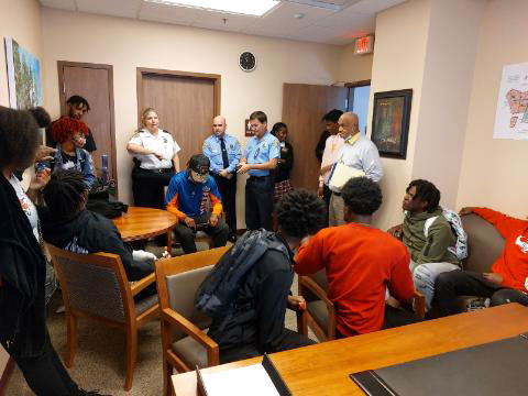 high school students in a workshop with the New Orleans Police Department learning about criminal justice