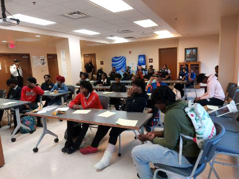 high school students in a workshop with the New Orleans Police Department learning about criminal justice